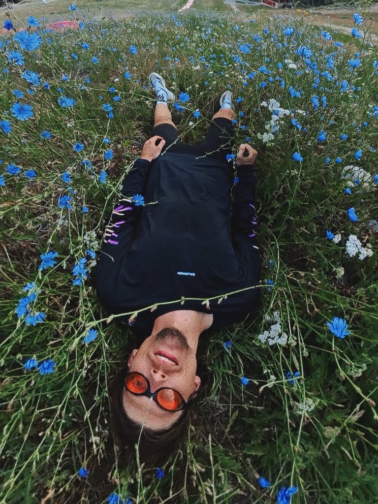 Lying in a field of blue flowers